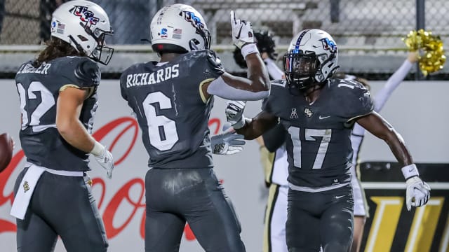 Nov 20, 2021; Orlando, Florida, USA; UCF Knights wide receiver Amari Johnson (17) celebrates his touchdown with running back Mark-Antony Richards (6) and tight end Alec Holler (82) against the Connecticut Huskies during the second half at Bounce House.